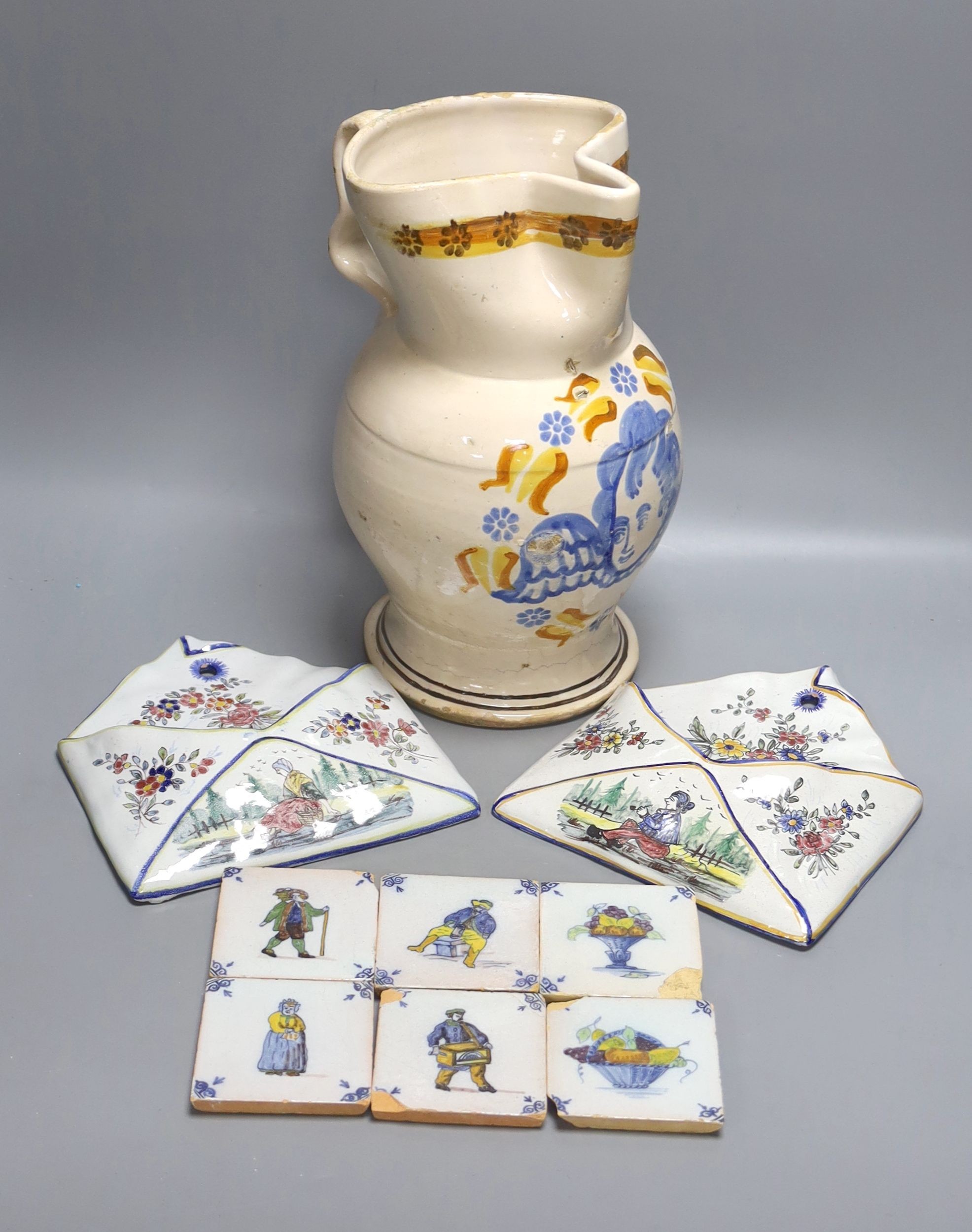 A pair of Delft wall brackets, a set of six delft small tiles and a large maiolica pitcher, height 30cm